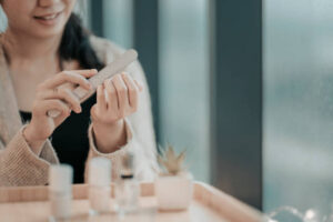 an asian chinese teenage girl polishing and coloring her finger nail