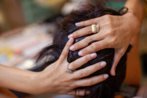 Woman hands touching her hair in hairdresser